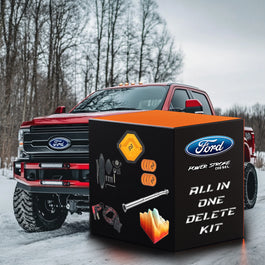 All-in-one Powerstroke 6.7 delete kit with ECMsync tuner, credits, block-off plates, wiring harness and straight delete pipe in box next to red Ford f350 truck.